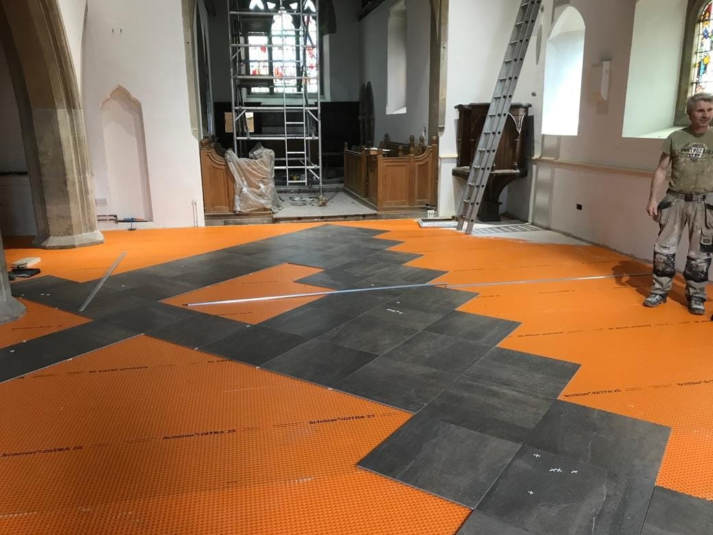 Orange matting between screed and tiles